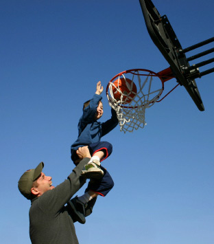 dad_bsktball Dad with son on basketball ring